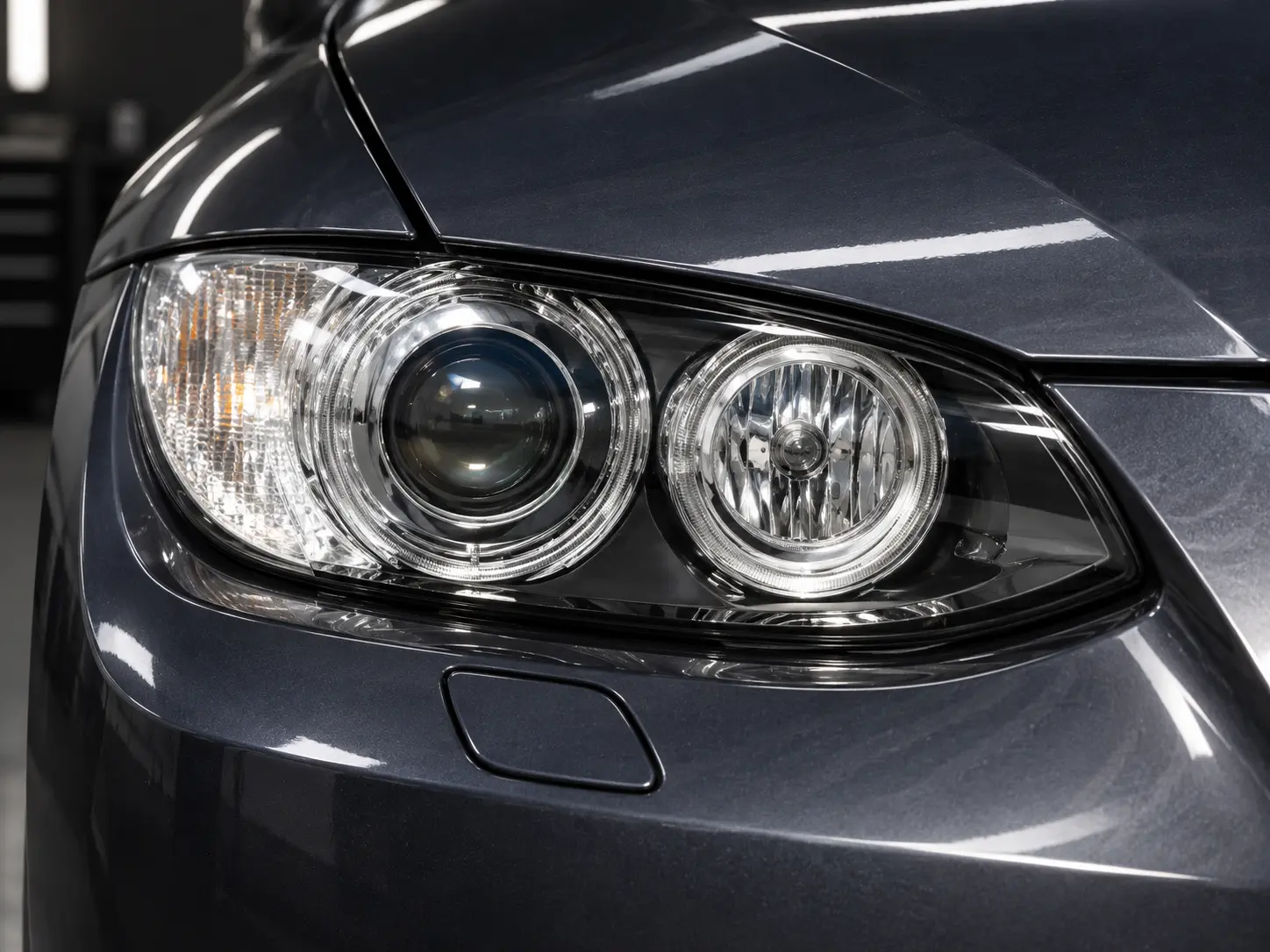 Clear BMW headlight lens in a professional detailing bay