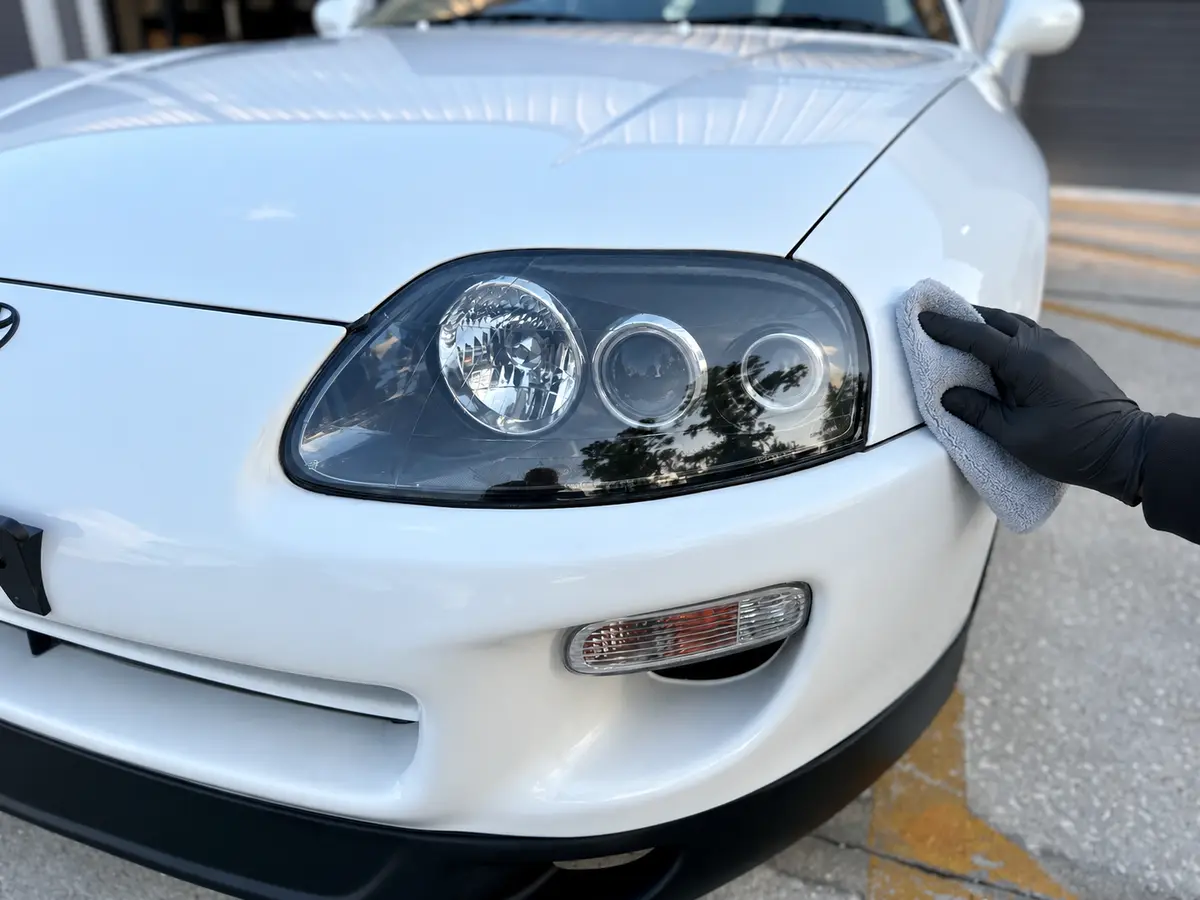 Restored Toyota Supra headlight during the final inspection after the 2K clear coat has cured